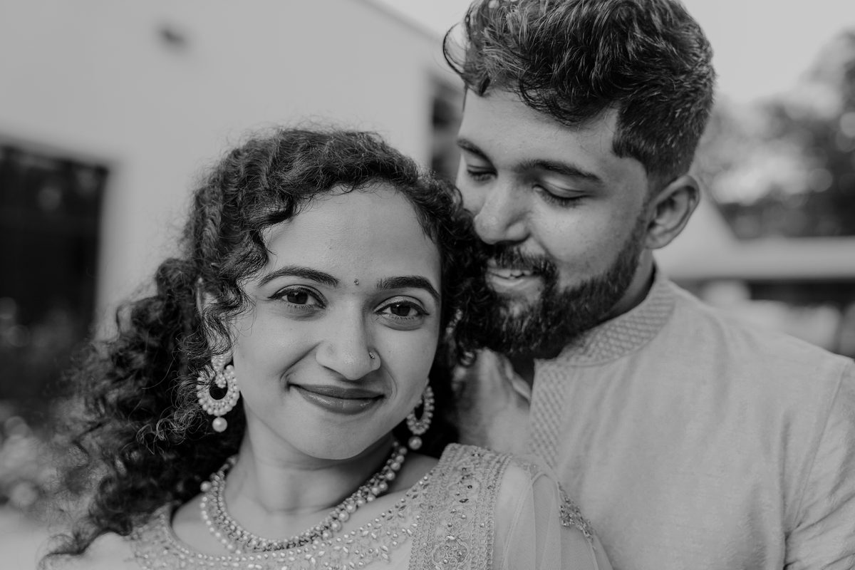 Black and white close portrait of a couple, cheek to cheek
