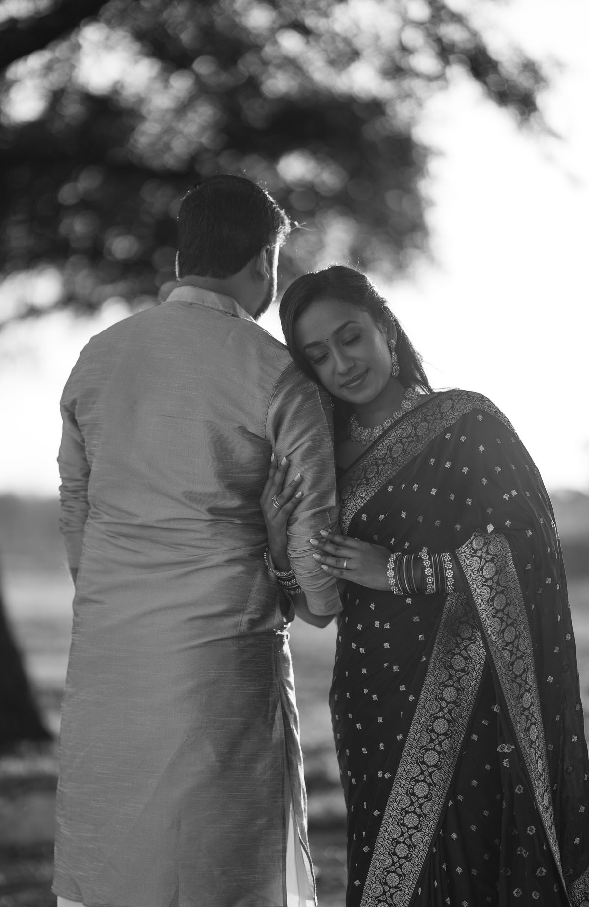 Black and white: a couple embracing under a tree