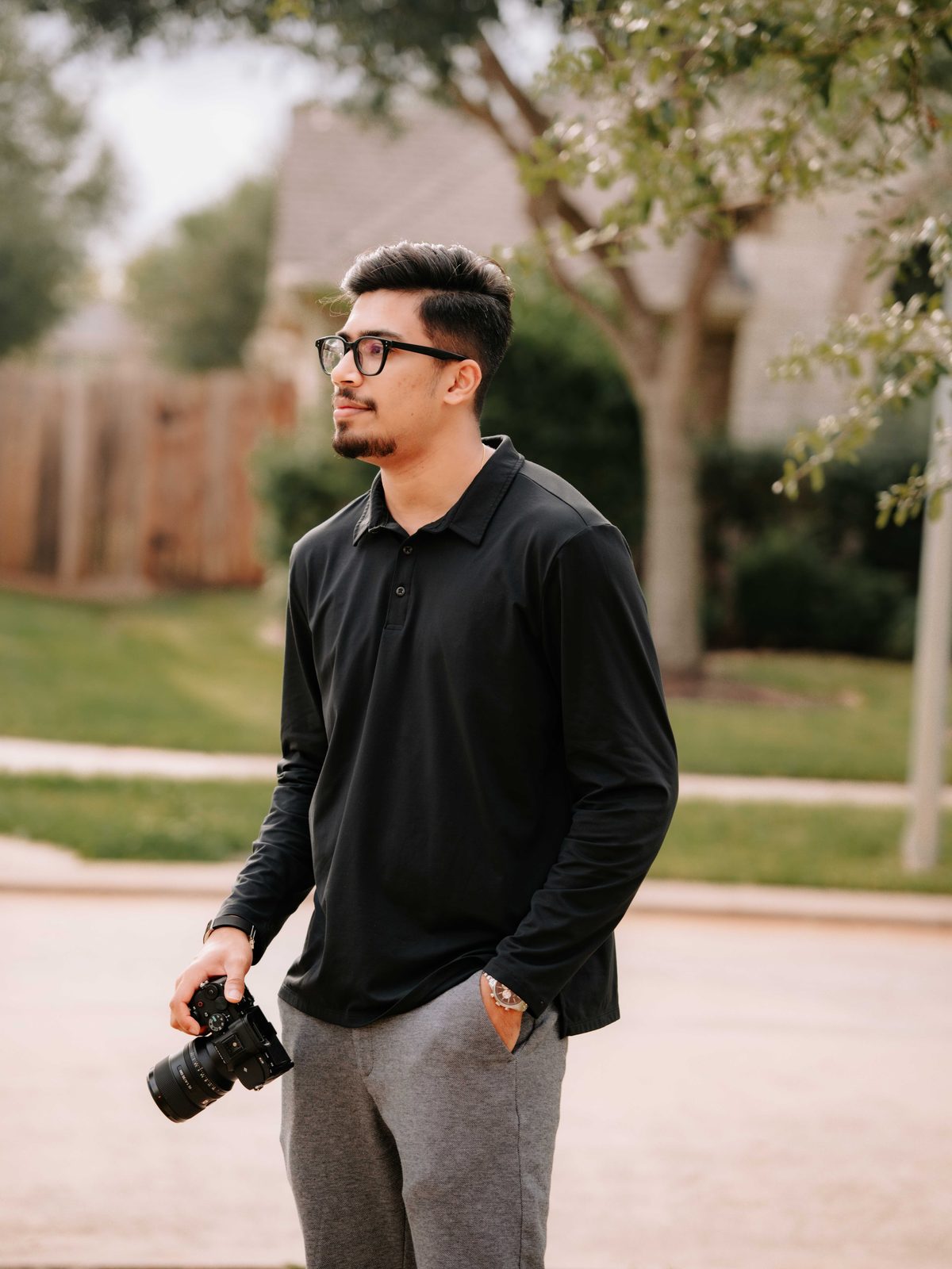 Joel Thomas Sam, camera in hand, outdoors